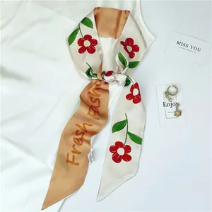 Detail of floral satin skinny scarf with Fresh Fashion lettering and vintage patterns