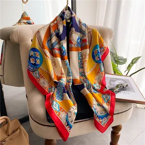 Detail of satin silk square scarf featuring nautical ropes and floral patterns