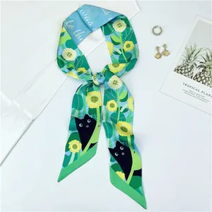 Detail of double-sided satin scarf featuring black cat and sunflower patterns