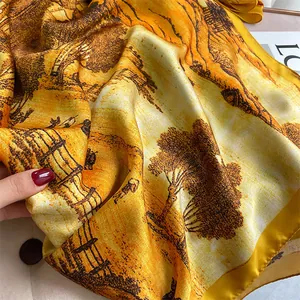 Macro detail of silk scarf featuring vintage oil painting landscape and yellow satin edge