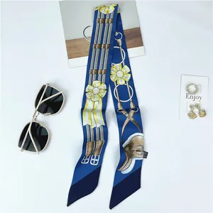 Elegant blue floral silk twilly scarf with yellow flower patterns and horse motifs
