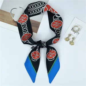 Detailed close-up of 100% silk skinny scarf featuring black chain pattern and blue accents