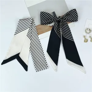 Detailed view of striped skinny silk scarf with diagonal edges and bow styling