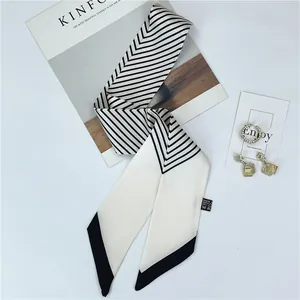 Off-white skinny twilly scarf with black geometric stripes and diagonal pointed ends