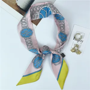 Detail of pink and blue chain print narrow silk scarf with elegant pointed ends