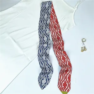 Detail of a dual-color floral silk scarf with retro blue and red wave patterns