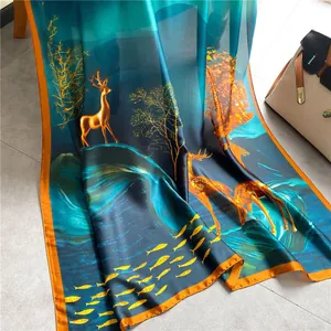 Artistic silk scarf with gold deer and fish pattern in deep teal and orange accents