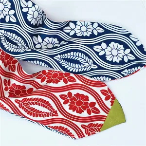 Detail of silk-like neck scarves with traditional Japanese floral patterns in blue and red