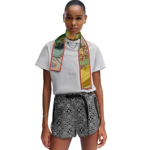Women's floral silk scarf paired with monogram high-waisted shorts and white logo T-shirt