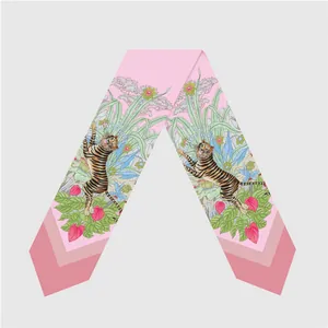 Detail of pink silk twilly scarf with tiger and tropical floral illustration print