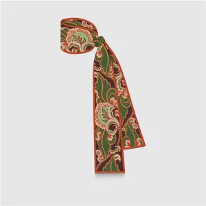 Close-up of lightweight twilly silk scarf with vintage floral paisley patterns