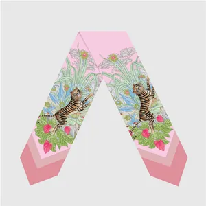 Detailed flat lay of pink silk twilly scarf featuring lovely tiger and jungle flora pattern