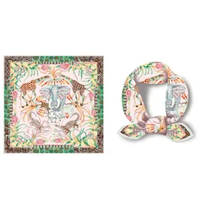 Detail of pink silk square scarf with African animal print showing elephant and giraffe motifs
