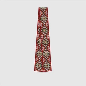 Macro shot of twilly scarf with vintage geometric floral print in silk-like fabric