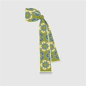 Detail of green floral silk scarf with vintage pattern tied to show drape and texture