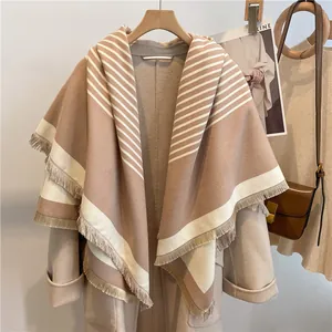Detailed view of camel striped cashmere shawl with elegant fringe and soft texture