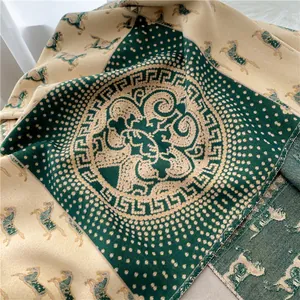 Detailed view of horse motif jacquard wool scarf with Greek key pattern and tassels