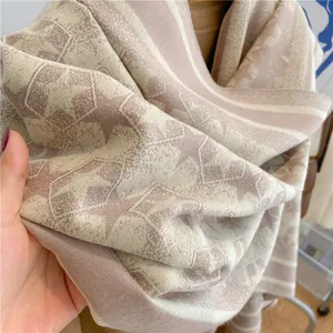 Close-up of star pattern cashmere-like scarf showing soft texture and bicolor knit details