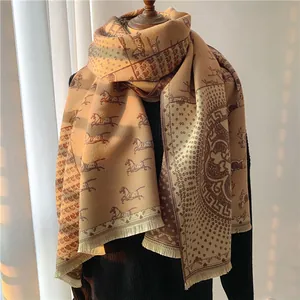 Detail of wool scarf with horse pattern, polka dots and fringe in beige and coffee brown