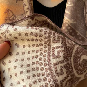 Detail of a thick wool scarf showing vintage horse carriage prints and soft texture