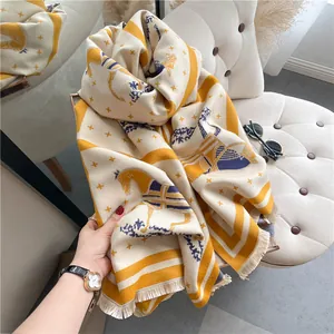 Detailed close-up of thick cashmere-like scarf with carriage pattern and short fringe