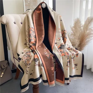 Detail of vintage floral pattern on thick beige shawl with elegant black tassels