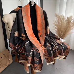 Detail of double-sided shawl with black and orange crane patterns and beige tassels