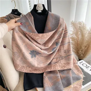 Detail of pink and blue cashmere-like shawl with lotus patterns and short tassels