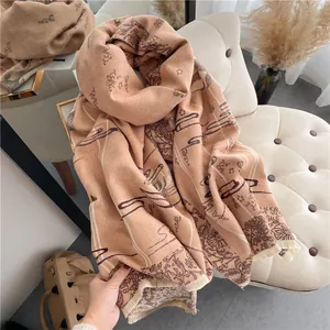Detail of soft cashmere-feel scarf featuring vintage floral patterns and fringe edges