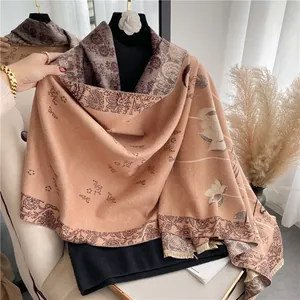 Thick cashmere-like scarf with blue porcelain floral patterns and handmade tassels