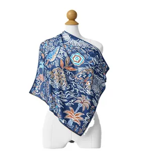 Navy blue silk-like square scarf with tropical palm tree print on female mannequin
