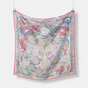 Detail view of ethnic print silk scarf showing knight armor and feather motifs on pink silk