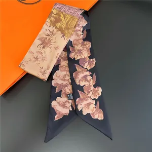 Close-up of double-sided silk twilly scarf with floral prints and washing instructions