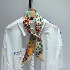 French vintage narrow silk scarf with paisley pattern tied on a white shirt collar
