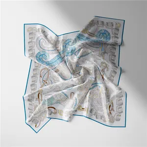 Detail of silk square scarf featuring artistic blue feather and horse harness prints