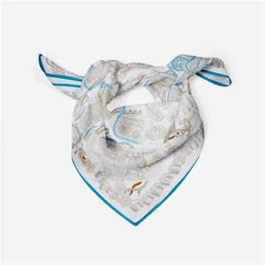 Detail of vintage pattern silk scarf with elegant chain and tassel prints on white base