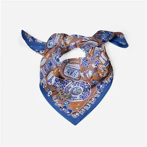 Close-up of silk scarf featuring vintage blue porcelain and buckle motifs