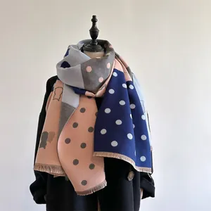 Detail view of thickened cashmere scarf featuring pink and blue patchwork with polka dots