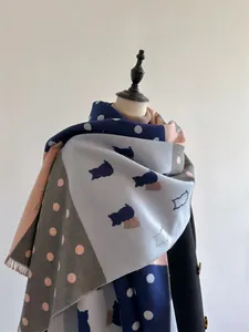 Detail of cashmere scarf with cat silhouette, colorful dots, and tassel trim edge