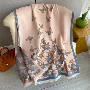 Detailed close-up of butterfly floral printed shawl with delicate white fringe accents