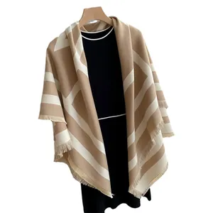 Faux cashmere shawl featuring khaki and white geometric color blocks and fringe trim