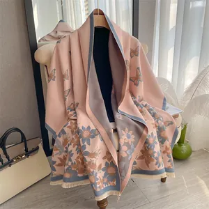 Close-up of elegant floral and butterfly print scarf with delicate fringe tassels