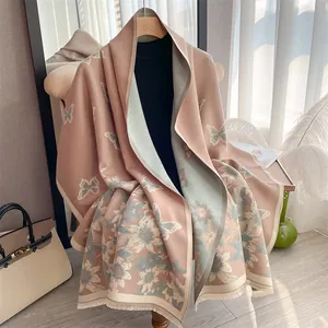 Detailed view of the double-sided floral butterfly print and fringed edge of the scarf