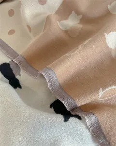 Close-up of cat pattern jacquard cashmere scarf with fine fringe trim and dots