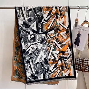 Detail of geometric pattern and fine tassel fringe on long bohemian ethnic style shawl