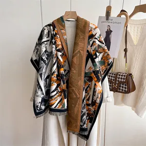 Detail of bohemian geometric print shawl with tassel trim and rich ethnic patterns