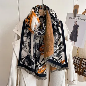 Detailed view of geometric pattern scarf with fringe, layered over a white coat