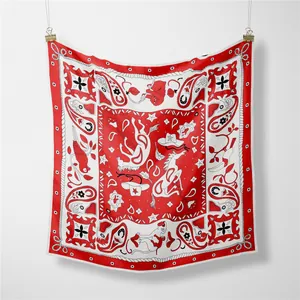 Detail showing red silk scarf with horse, cowboy hat, and paisley patterns on white background