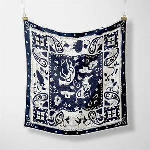 Detailed close-up of navy blue twill silk square scarf with western paisley patterns