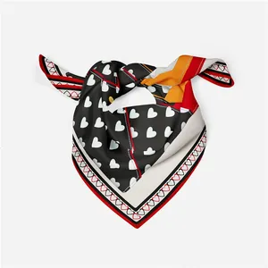 Detail of silk square scarf featuring heart and polka dot patterns with high-gloss finish